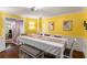Formal dining room features yellow walls, a long table, and elegant decor at 4259 Kings Troop Rd, Stone Mountain, GA 30083