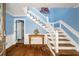 Foyer with hardwood floors, stairs, wainscotting, and wood trim at 4259 Kings Troop Rd, Stone Mountain, GA 30083
