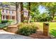 Beautifully landscaped front yard with mature trees and a well maintained lawn at 4259 Kings Troop Rd, Stone Mountain, GA 30083