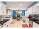 Eat-in kitchen boasts white cabinets, black countertops, and stainless steel appliances at 4259 Kings Troop Rd, Stone Mountain, GA 30083