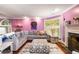 Open-concept living room with stylish decor, plush seating, and natural light from large windows at 4259 Kings Troop Rd, Stone Mountain, GA 30083