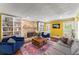 Bright living room featuring a brick fireplace, hardwood floors, and built-in bookshelves at 4259 Kings Troop Rd, Stone Mountain, GA 30083