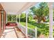 Inviting front porch with a porch swing and brick flooring at 4259 Kings Troop Rd, Stone Mountain, GA 30083