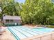 Large swimming pool area with lounge chairs and recreational building, perfect for community enjoyment at 4259 Kings Troop Rd, Stone Mountain, GA 30083