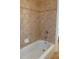 Bathroom featuring tiled walls, a tub, and chrome shower fixtures at 430 English Ivy Way, Woodstock, GA 30188