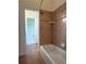 Bathroom featuring tiled walls and a white bathtub at 430 English Ivy Way, Woodstock, GA 30188