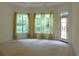 Bedroom with natural light, sheer curtains, and backyard access at 430 English Ivy Way, Woodstock, GA 30188
