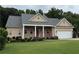 Charming single-story home with a brick facade, manicured lawn, and a covered entrance with elegant white columns at 430 English Ivy Way, Woodstock, GA 30188