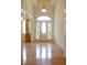 Elegant foyer with hardwood floors, a front door with glass, and tall ceilings with natural light at 430 English Ivy Way, Woodstock, GA 30188