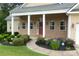 Beautiful home with manicured landscaping, a brick facade, and a welcoming red front door at 430 English Ivy Way, Woodstock, GA 30188