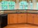 Updated kitchen featuring wood cabinets, black appliances, granite countertops, and natural light at 430 English Ivy Way, Woodstock, GA 30188