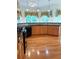 Spacious kitchen with wood cabinets, dark countertops, hardwood floors, and large windows overlooking the backyard at 430 English Ivy Way, Woodstock, GA 30188