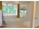 Spacious living room with large windows overlooking the backyard and access to other rooms at 430 English Ivy Way, Woodstock, GA 30188