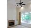 Bright living room with fireplace, ceiling fan, and large windows offering plenty of natural light at 430 English Ivy Way, Woodstock, GA 30188