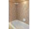 Shower featuring neutral-toned tile walls and built-in soap dish at 430 English Ivy Way, Woodstock, GA 30188