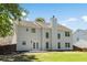 Two-story home featuring a spacious backyard, patio, and manicured lawn at 795 Creek Glen Rd, Mableton, GA 30126