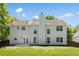 Exterior of a home with a spacious backyard, well-maintained lawn, and fenced perimeter at 795 Creek Glen Rd, Mableton, GA 30126