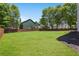 A spacious fenced backyard with lush green grass, perfect for outdoor activities and relaxation at 795 Creek Glen Rd, Mableton, GA 30126