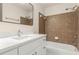Modern bathroom with marble countertops, stylish vanity, and shower-tub combo at 795 Creek Glen Rd, Mableton, GA 30126