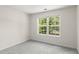 Inviting bedroom with a large window allowing natural light and peaceful outdoor views at 795 Creek Glen Rd, Mableton, GA 30126