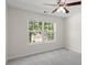 Bright bedroom featuring a ceiling fan and a large window with a view of the outdoors at 795 Creek Glen Rd, Mableton, GA 30126