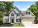 Charming two-story home with a manicured lawn, attached two-car garage, and inviting blue shutters at 795 Creek Glen Rd, Mableton, GA 30126