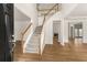 Inviting foyer with hardwood flooring, staircase, and views into the living spaces at 795 Creek Glen Rd, Mableton, GA 30126