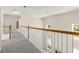 Bright upstairs hallway showcasing hardwood railing, white balusters, and ample natural light at 795 Creek Glen Rd, Mableton, GA 30126