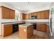 This is a kitchen with wooden cabinets, a center island, and modern appliances at 795 Creek Glen Rd, Mableton, GA 30126