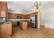 A spacious kitchen featuring wood cabinets, stainless steel appliances, and a center island at 795 Creek Glen Rd, Mableton, GA 30126