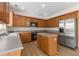 Bright kitchen with wood cabinets, stainless steel appliances, and a practical center island at 795 Creek Glen Rd, Mableton, GA 30126