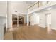 Open-concept living room with hardwood flooring, high ceilings, fireplace, and views of the kitchen at 795 Creek Glen Rd, Mableton, GA 30126