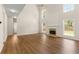 Bright and airy living room with hardwood floors, fireplace, and large windows at 795 Creek Glen Rd, Mableton, GA 30126