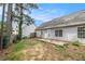 View of the backyard with a concrete patio and mature trees at 104 Terrapin Ct, Carrollton, GA 30116