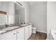 Bathroom featuring double sinks, tub with shower, and white cabinets at 104 Terrapin Ct, Carrollton, GA 30116
