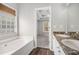 Bathroom featuring double vanity with granite countertop, bathtub, and view of the Primary bedroom at 104 Terrapin Ct, Carrollton, GA 30116