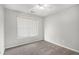 Neutral bedroom with carpet flooring, ceiling fan, and a window offering natural light at 104 Terrapin Ct, Carrollton, GA 30116