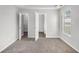 Bright bedroom featuring neutral walls, carpet flooring, and access to both a walk-in closet and ensuite bathroom at 104 Terrapin Ct, Carrollton, GA 30116