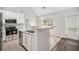 Modern kitchen featuring stainless steel appliances, granite countertops, white cabinetry, and tile flooring at 104 Terrapin Ct, Carrollton, GA 30116