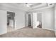 Bright main bedroom with neutral walls, plush carpet, and vaulted ceiling with a view of the kitchen and bathroom at 104 Terrapin Ct, Carrollton, GA 30116
