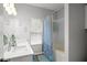 Bright bathroom with double vanity, quartz countertops, and tub-shower with patterned curtain at 2061 Pinnacle Pointe Dr, Norcross, GA 30071