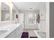 Bright bathroom with double vanity, marble counters, glass shower, and natural light from large window at 2061 Pinnacle Pointe Dr, Norcross, GA 30071