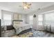 Bright bedroom with ceiling fan, large windows, and a modern design and decor at 2061 Pinnacle Pointe Dr, Norcross, GA 30071