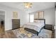 Cozy bedroom with tray ceiling, ceiling fan, and neutral decor, with accent rug and furniture at 2061 Pinnacle Pointe Dr, Norcross, GA 30071