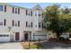 Traditional townhome featuring red shutters, mature landscaping, and attached one-car garage at 2061 Pinnacle Pointe Dr, Norcross, GA 30071