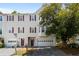 Traditional townhome featuring red shutters, mature landscaping, and attached one-car garage at 2061 Pinnacle Pointe Dr, Norcross, GA 30071