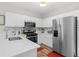Charming kitchen with stainless steel appliances, quartz countertops, and wood flooring at 2061 Pinnacle Pointe Dr, Norcross, GA 30071