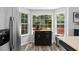 Well-lit kitchen with view, stainless steel refrigerator, and rolling island with wood countertop at 2061 Pinnacle Pointe Dr, Norcross, GA 30071