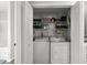 Practical laundry closet with washer, dryer, and shelving for convenient storage at 2061 Pinnacle Pointe Dr, Norcross, GA 30071