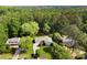 A lush treeline surrounds this charming single-story home with driveway and well-kept lawn at 3519 Oak Knoll Dr, Marietta, GA 30068